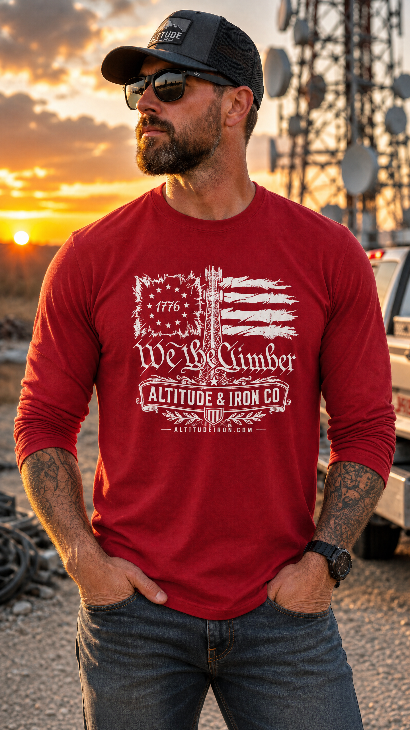 A man wearing a red long-sleeve graphic t-shirt with a distressed white American flag and 'We The Climber' text, set against a sunset outdoor background with satellite dishes.