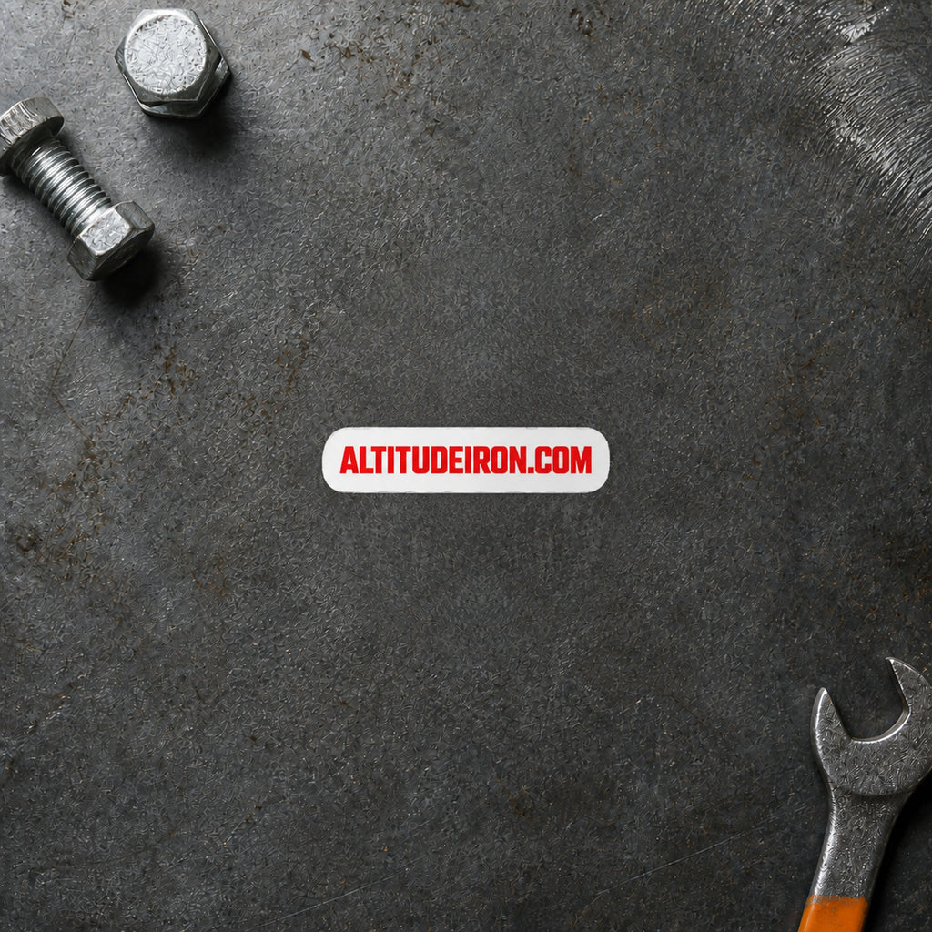 AltitudeIron.com wordmark sticker displayed on a steel workbench