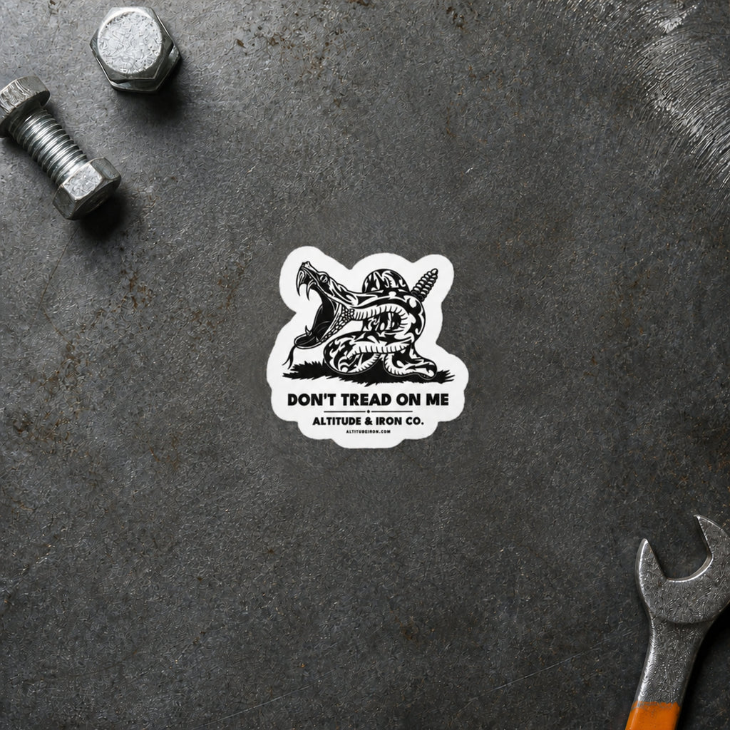 Don't Tread on Me rattlesnake sticker displayed on a steel workbench