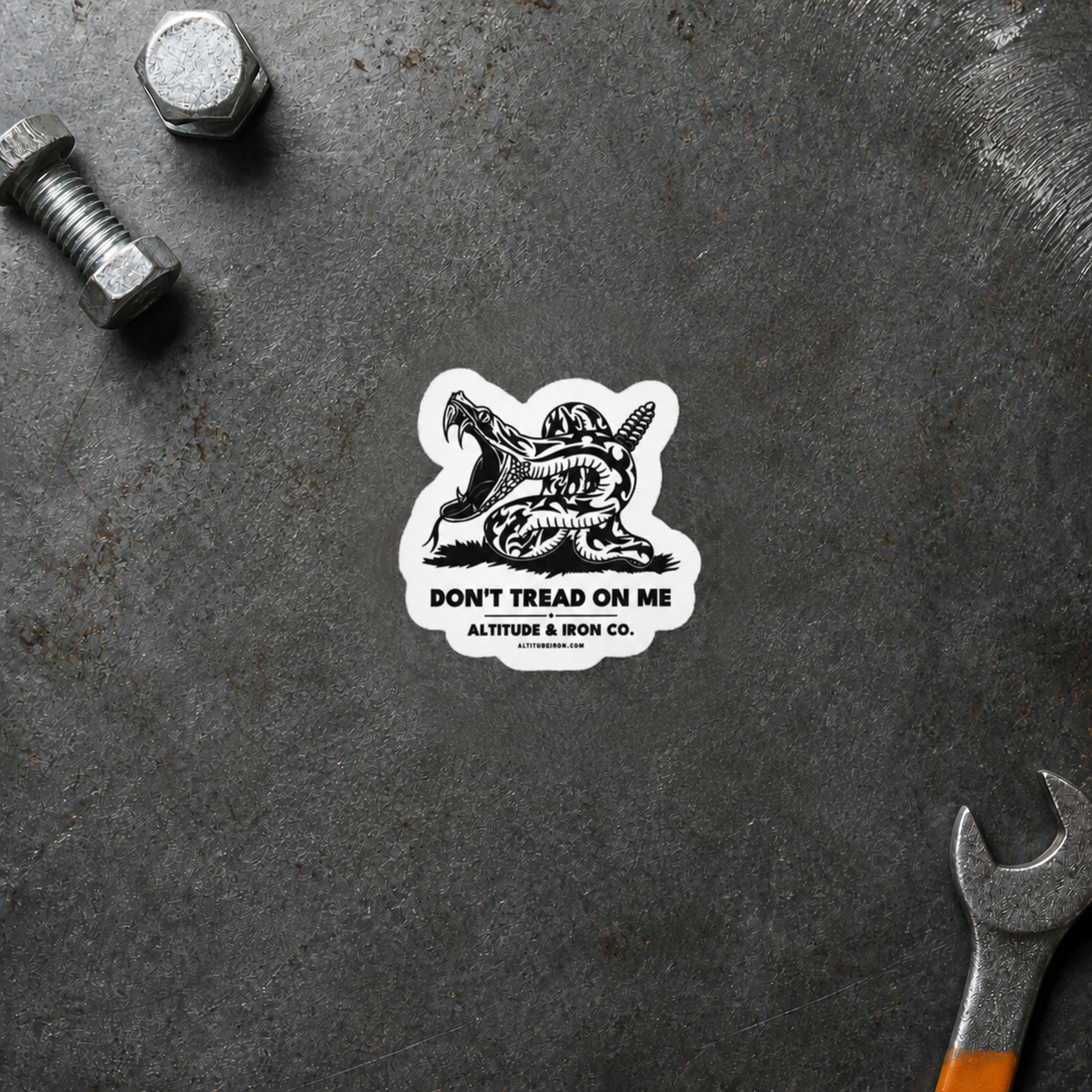 Don't Tread on Me rattlesnake sticker displayed on a steel workbench