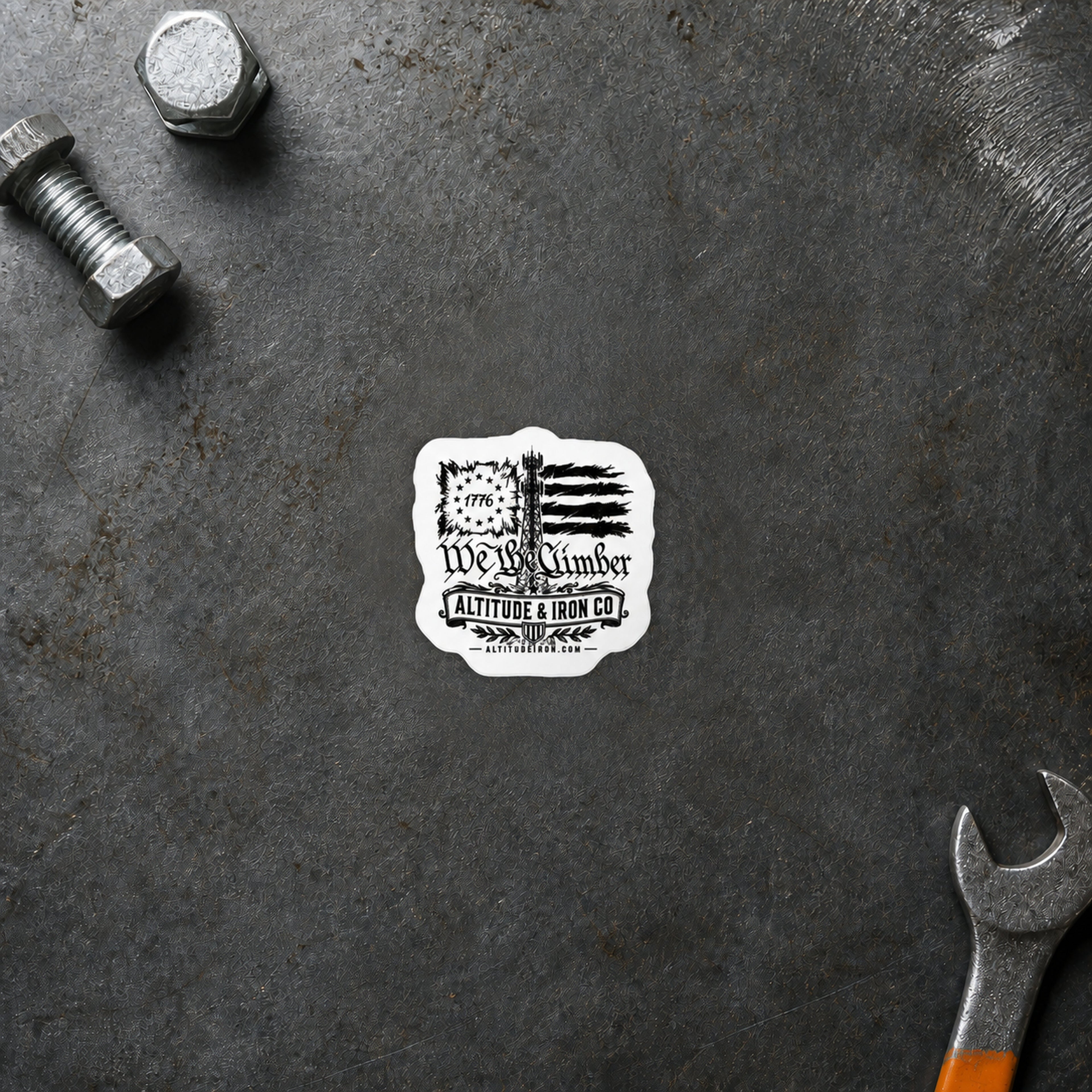 We the Climber sticker displayed on a steel workbench